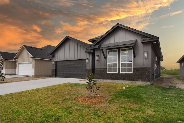 3633 Rebecca Dr, Corpus Christi, TX 78410 - view of front of property with concrete driveway, board and batten siding, a yard, and an attached garage
