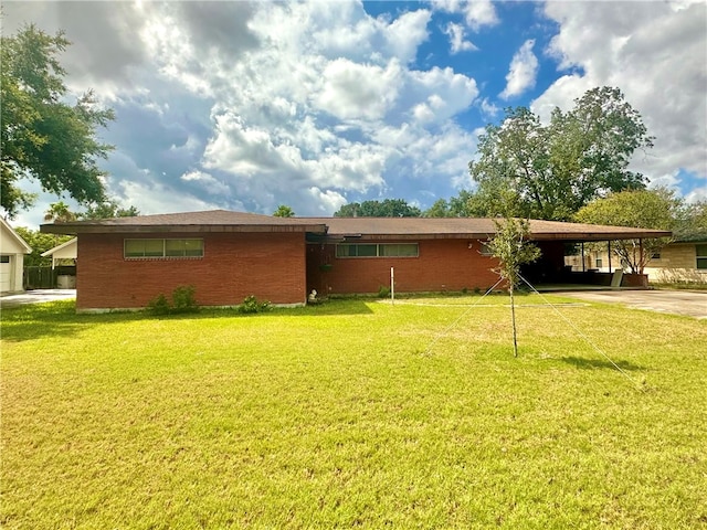 rear view of house with a yard and a carport