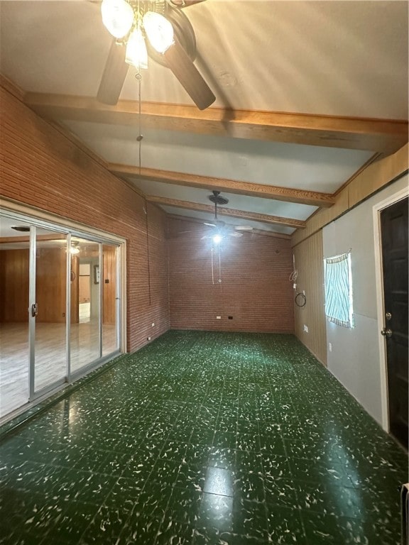 unfurnished room featuring lofted ceiling with beams, wood walls, and ceiling fan