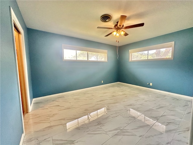 unfurnished room featuring ceiling fan and a textured ceiling