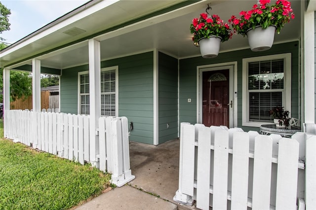 view of exterior entry with a porch