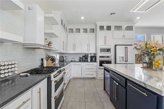 15130 Reales Dr, Corpus Christi, TX 78418 - kitchen with premium appliances, open shelves, white cabinetry, light tile patterned floors, and recessed lighting