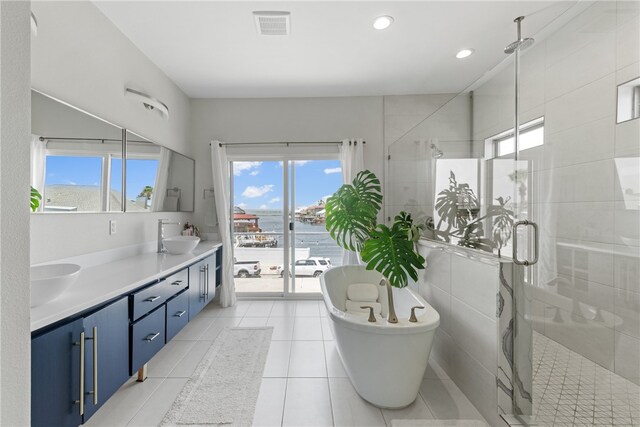 15130 Reales Dr, Corpus Christi, TX 78418 - bathroom featuring double vanity, a shower stall, plenty of natural light, a soaking tub, and recessed lighting