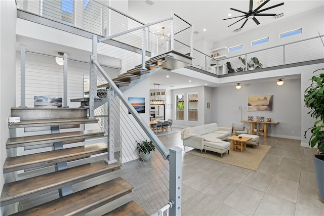 15130 Reales Dr, Corpus Christi, TX 78418 - staircase featuring a high ceiling, tile patterned floors, recessed lighting, a chandelier, and a ceiling fan