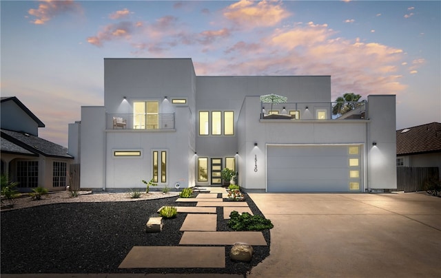 15130 Reales Dr, Corpus Christi, TX 78418 - contemporary home with a balcony, driveway, an attached garage, and stucco siding