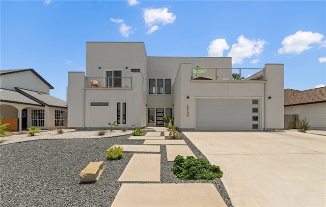 15130 Reales Dr, Corpus Christi, TX 78418 - view of front facade featuring a balcony, driveway, a garage, and stucco siding