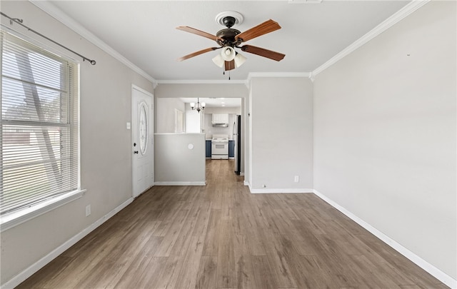 5302 Bonham St, Corpus Christi, TX 78415 - unfurnished living room featuring a ceiling fan, ornamental molding, plenty of natural light, a chandelier, and wood finished floors
