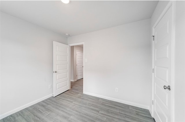 unfurnished bedroom with light wood-type flooring