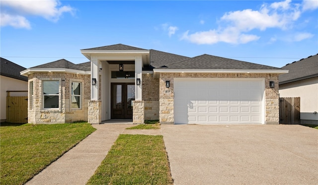 view of front of property with a front yard and a garage