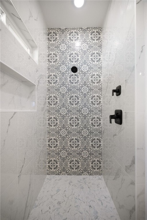 bathroom with a tile shower