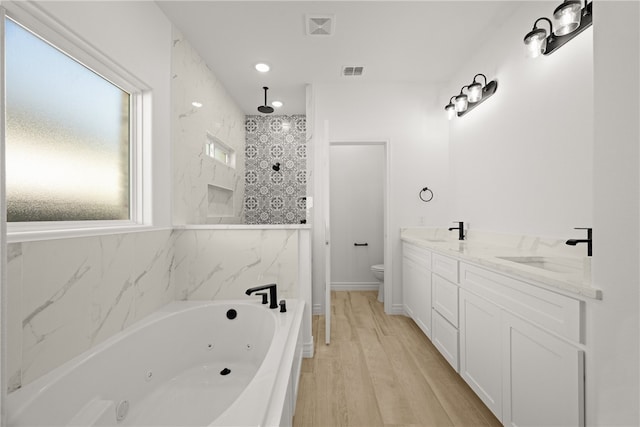 full bathroom featuring hardwood / wood-style flooring, vanity, toilet, and plus walk in shower