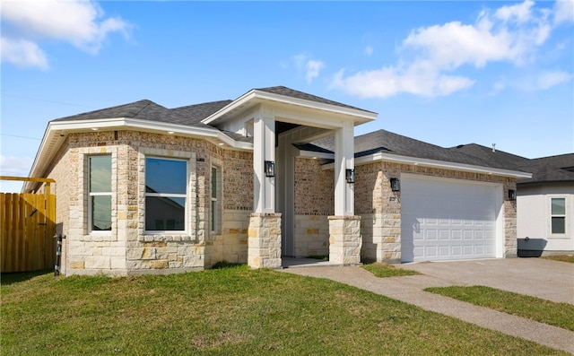 view of front facade with a front yard and a garage