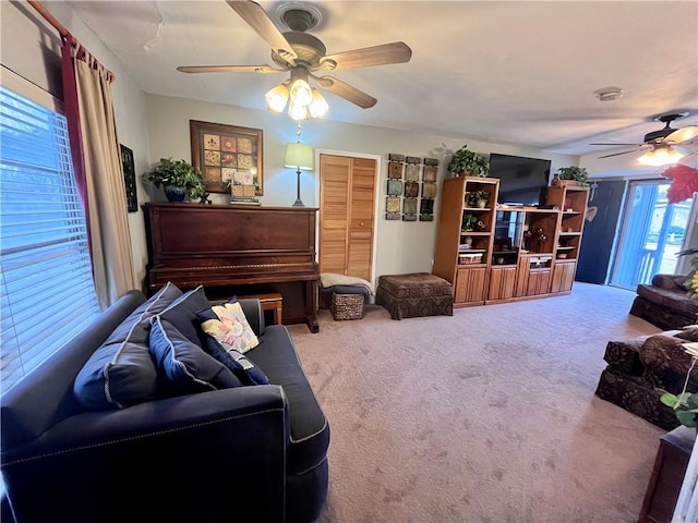 living room featuring carpet and ceiling fan