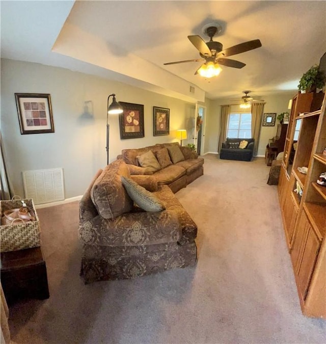 carpeted living room featuring ceiling fan