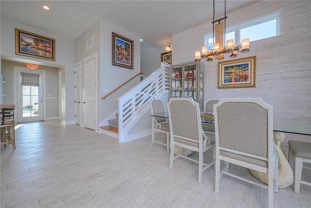 dining area featuring light hardwood / wood-style flooring and a notable chandelier