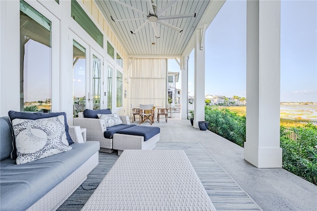 sunroom / solarium featuring ceiling fan