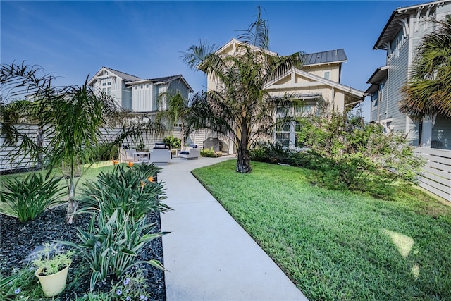 view of property's community with a lawn and a patio