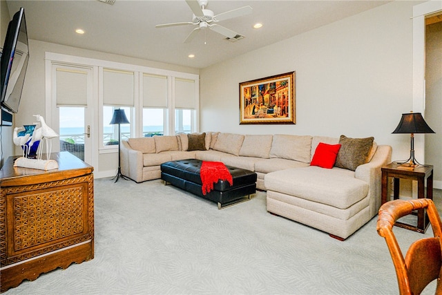 living room with light colored carpet and ceiling fan