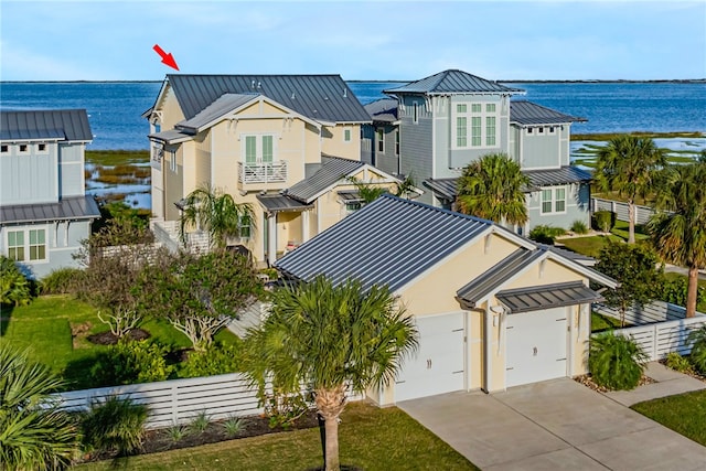 view of front of house with a garage and a water view