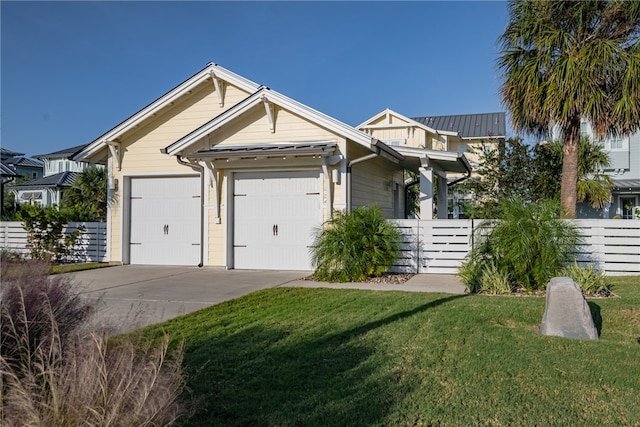 view of front of home with a front lawn and a garage