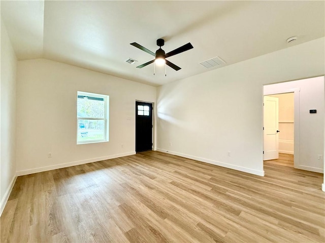 empty room featuring ceiling fan, lofted ceiling, and light hardwood / wood-style flooring