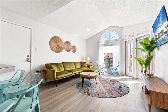 living area with recessed lighting, visible vents, a textured ceiling, and light colored carpet