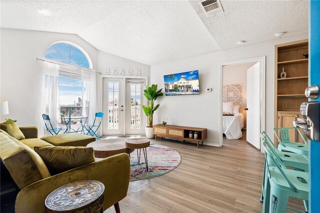 living room with light carpet, visible vents, recessed lighting, and a textured ceiling