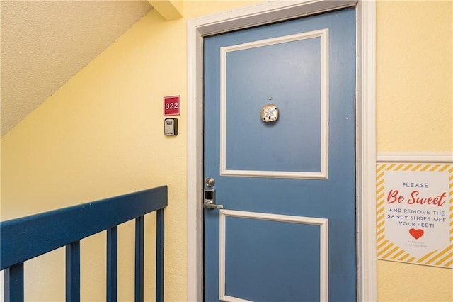 property entrance with stucco siding