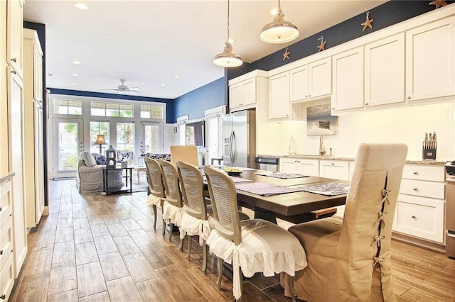 dining room featuring ceiling fan, french doors, and sink