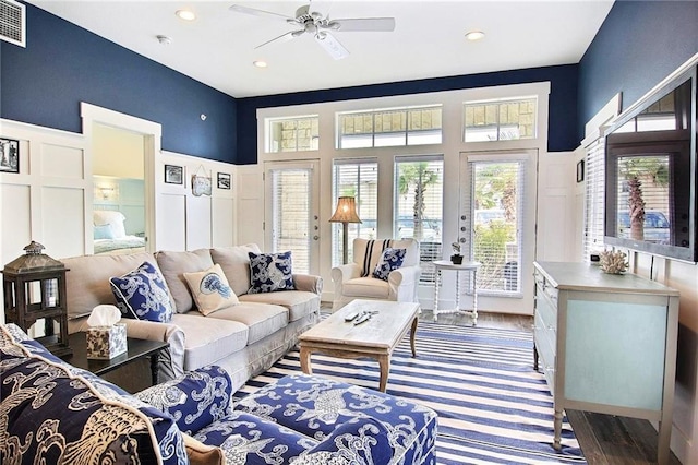 living room featuring ceiling fan and hardwood / wood-style floors