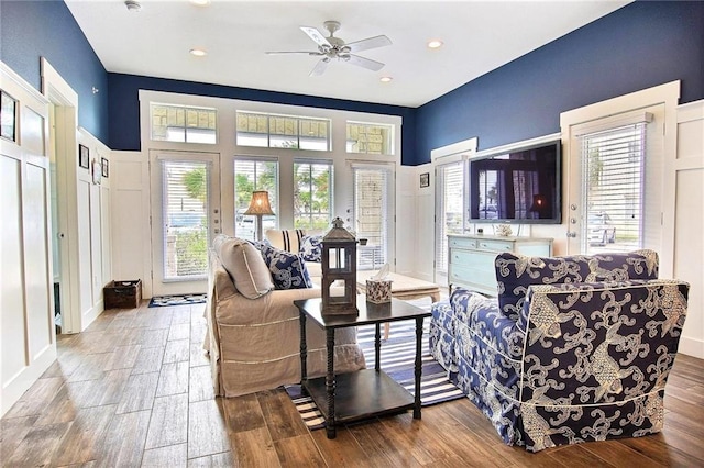 living room with wood-type flooring and ceiling fan