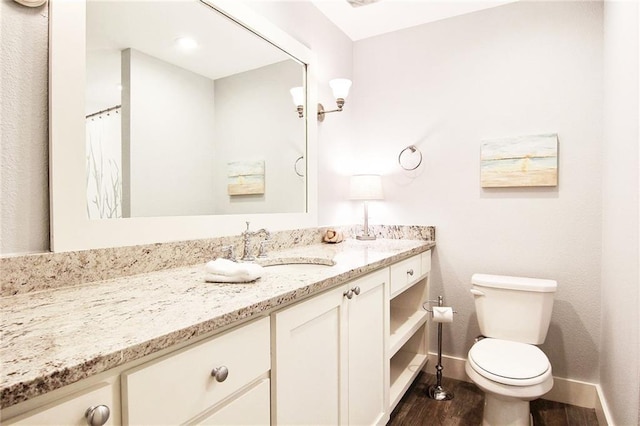 bathroom with walk in shower, toilet, vanity, and hardwood / wood-style flooring