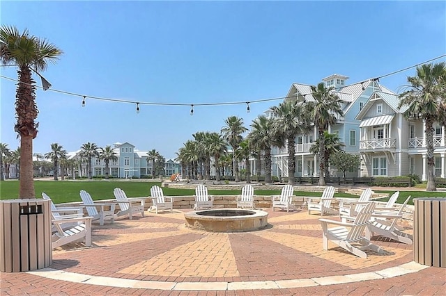 view of property's community with an outdoor fire pit and a patio area