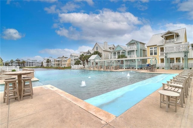 view of pool featuring pool water feature and a patio area