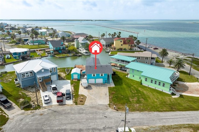 drone / aerial view with a water view and a residential view