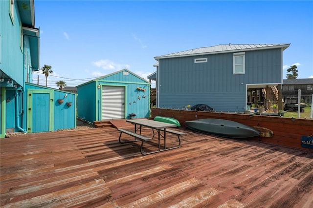 wooden terrace with a storage unit and an outbuilding