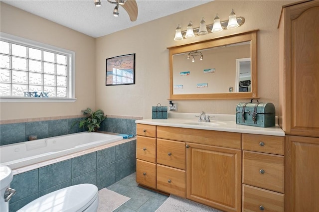 bathroom featuring vanity, toilet, tile patterned floors, a ceiling fan, and a bath