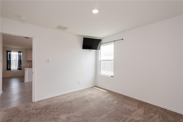 13245 Wrangler St, Robstown, TX 78380 - unfurnished room with carpet, visible vents, and baseboards