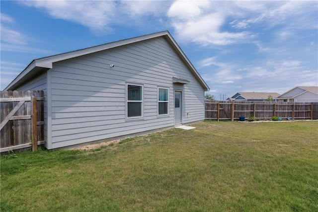 13245 Wrangler St, Robstown, TX 78380 - back of house featuring a lawn and a fenced backyard