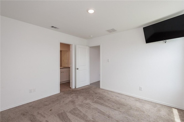 13245 Wrangler St, Robstown, TX 78380 - unfurnished bedroom featuring connected bathroom, carpet floors, baseboards, and visible vents