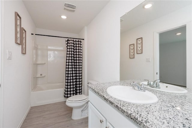 13245 Wrangler St, Robstown, TX 78380 - full bath with toilet, wood finished floors, vanity, recessed lighting, and shower / tub combo