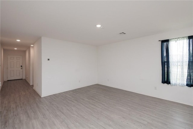 13245 Wrangler St, Robstown, TX 78380 - empty room with light wood finished floors, baseboards, and recessed lighting