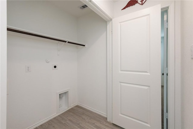 13245 Wrangler St, Robstown, TX 78380 - laundry area featuring laundry area, visible vents, electric dryer hookup, baseboards, and light wood-style floors