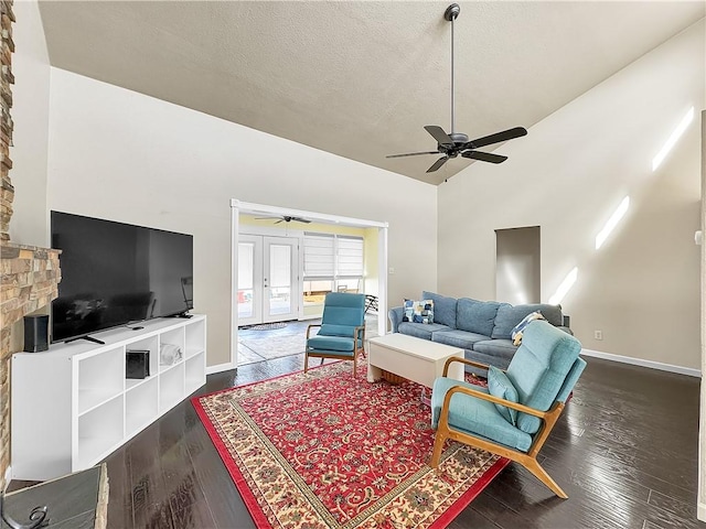 living area with a textured ceiling, a ceiling fan, wood finished floors, french doors, and baseboards