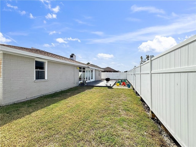 view of yard featuring a fenced backyard and a patio area