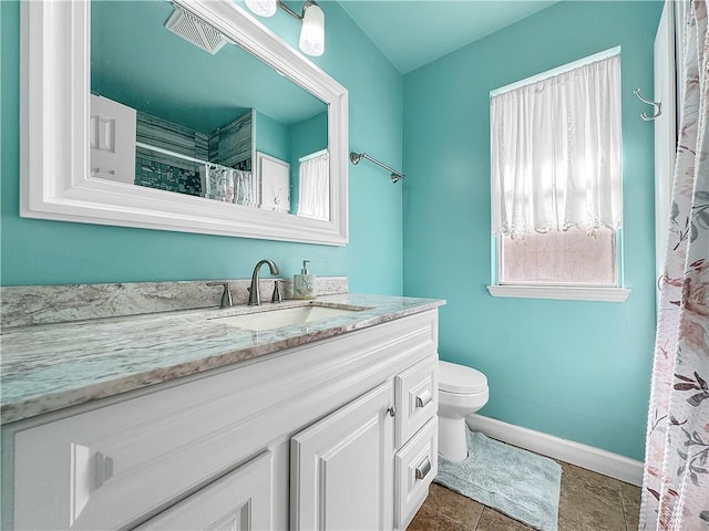 bathroom with visible vents, toilet, vanity, and baseboards