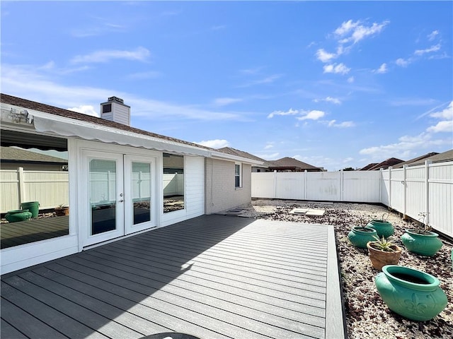 deck with french doors and a fenced backyard