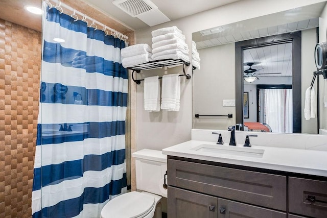 full bathroom featuring vanity, toilet, curtained shower, and visible vents