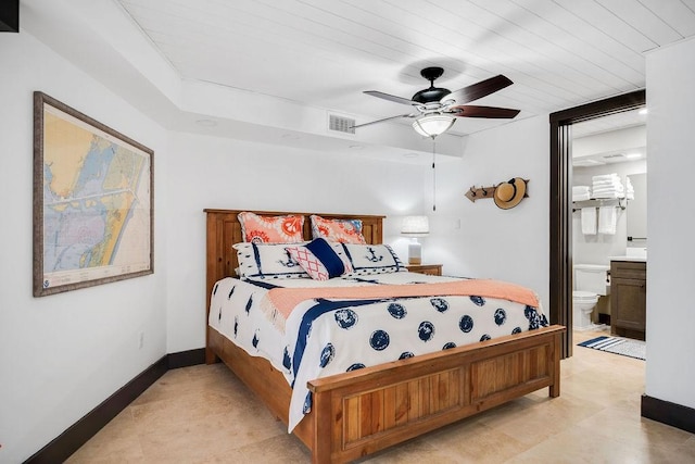 bedroom with ceiling fan, baseboards, visible vents, and ensuite bathroom