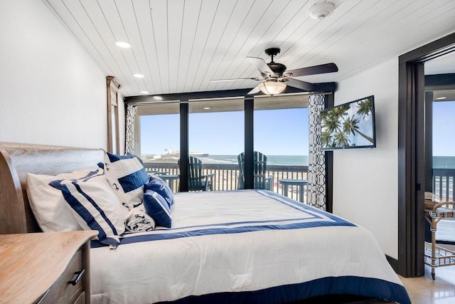 bedroom with wooden ceiling, access to exterior, multiple windows, and a wall of windows